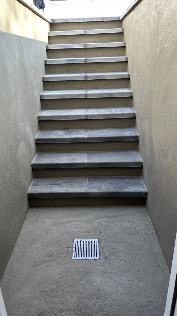 Custom two wall basement walkout entrance with concrete stairs in Smithtown, NY